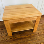 Pair of solid oak end tables with a clean, sturdy profile and practical lower shelves.