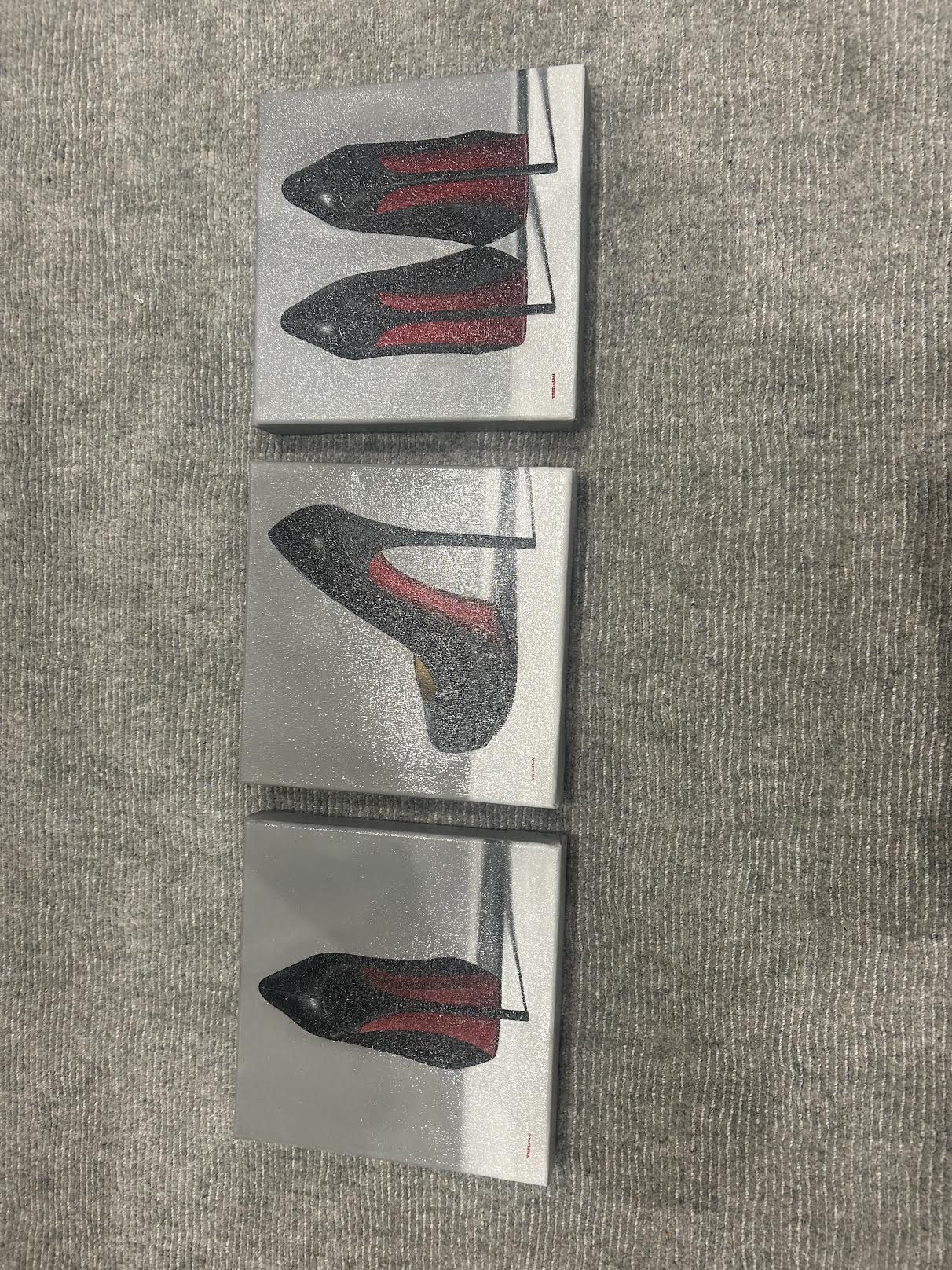 Straight-on view of all three Joanne Helman shoe paintings; each painting is listed separately